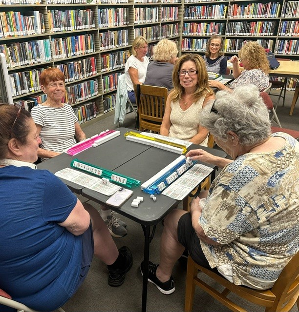 people playing mahjong in the library